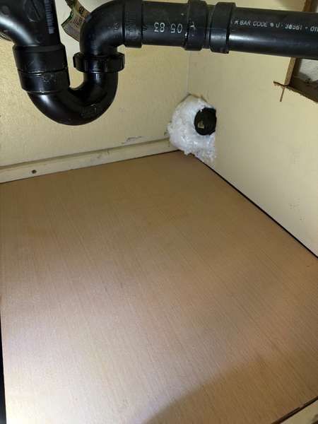 New plywood floor set flush on a cleat, entry points sealed.