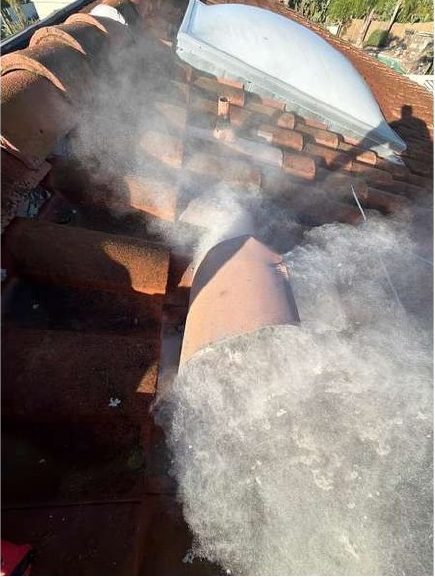 Lint discharging at the jack as the run was brushed through with the dryer running.