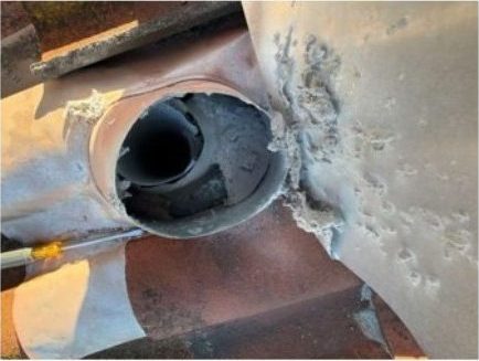 The duct throat behind the cap on arrival, packed solid with compacted lint.